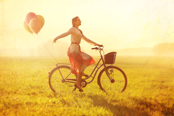 Woman on a Bike with balloons