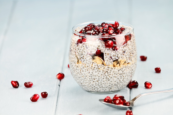 Chia seed parfait made with pomegranate, oats and almonds with extreme shallow depth of field.